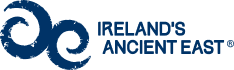 Ireland's Ancient East logo featuring two dark blue swirling spiral symbols.